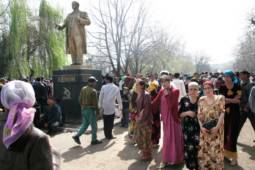 HISSAR, DUSHANBE, TAJIKISTAN - MARCH, 2005: Statue of Lenin looking of a holiday crowd.  For the Muslim festival  of Navrus.  It takes place around the spring equinox (March 21) and is the biggest Central Asia holiday. Most young women in Tajikistan can be seen wearing brightly colored traditional dresses during the holidays. (Photo by Christopher Herwig)